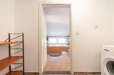 a hallway with a door leading to a laundry room at Artzy Villa in Rhodes Town