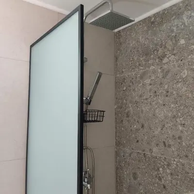 a shower with a glass door in a bathroom at Anastasia Hotel in Symi