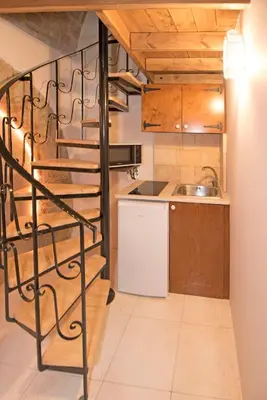 a kitchen with a spiral staircase and a sink at Athina house in Rhodes Town