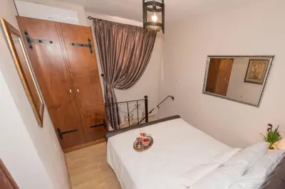 a small room with a bed and a mirror at Athina house in Rhodes Town