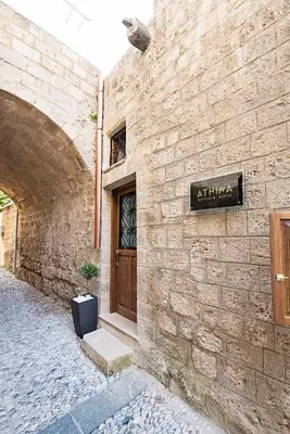 a stone building with a door and a sign on it at Athina house in Rhodes Town