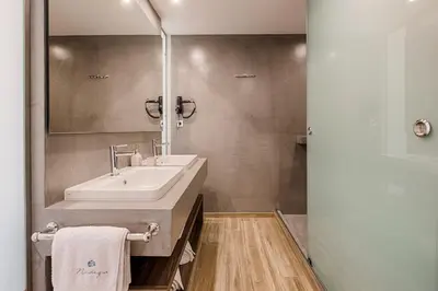 a bathroom with a sink and a mirror at Nastazia Luxury Beach House in Ialyssos