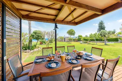 a wooden table and chairs on a patio at Nastazia Luxury Beach House in Ialyssos