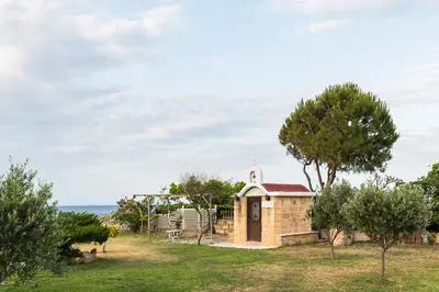 a small chapel with the ocean in the background at Nastazia Luxury Beach House in Ialyssos