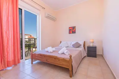a bedroom with a bed and a large window at Lina's Amazing House in Ialysos in Ixia