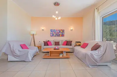 a living room with a couch and a table at Lina's Amazing House in Ialysos in Ixia