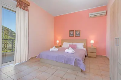 a bedroom with a bed and a large window at Lina's Amazing House in Ialysos in Ixia