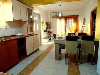 a kitchen with a table and chairs in a room at Cozy apartment in Paradisi in Paradeísion
