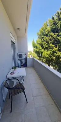 a balcony with a table and a chair on a balcony at Retas apartment up in Kremasti