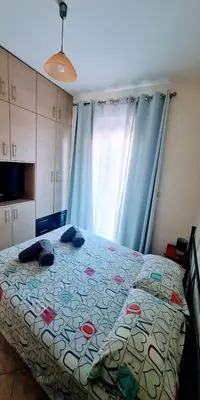 a bedroom with a bed with a comforter on it at Retas apartment up in Kremasti