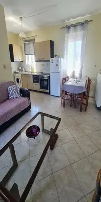 a living room with a couch and a table at Retas apartment up in Kremasti