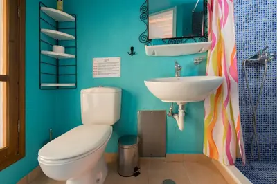 a bathroom with a toilet and a sink at Serene House,Beautiful Garden in Old Town in Rhodes Town