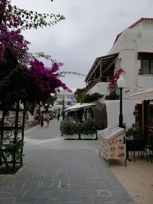 a street with a sign on a sidewalk next to a building at Casa Elettra in Rhodes Town