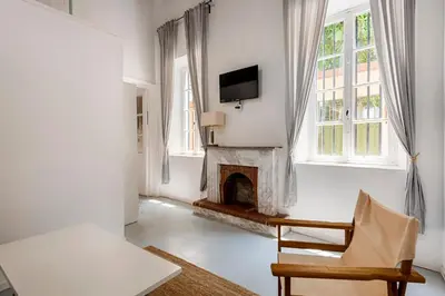 a living room with a fireplace and a tv at Casa Elettra in Rhodes Town
