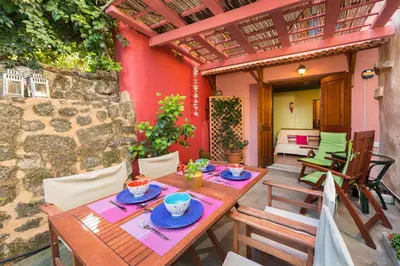 a wooden table and chairs on a patio at Old Town House with Garden, Fully Equipped & Peaceful in Rhodes Town