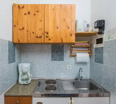 a kitchen with a sink and a counter top at Poseidon Apartment in Archangelos