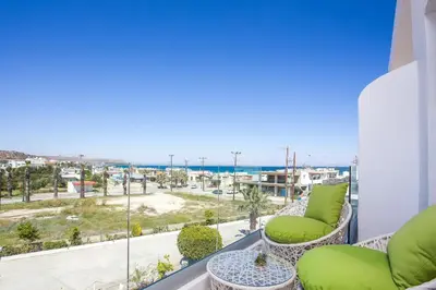 a balcony with chairs and a view of the ocean at Ammos Luxury Suites in Faliraki
