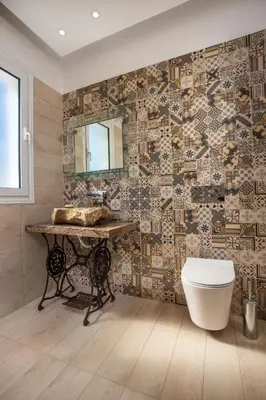 a bathroom with a sink and a mirror on a wall at Ammos Luxury Suites in Faliraki