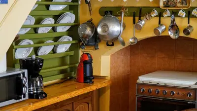a kitchen with a counter with plates and utensils at Moschos Mansion in Symi