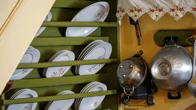 a rack of plates and utensils in a kitchen at Moschos Mansion in Symi