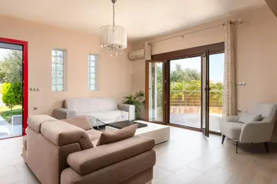 a living room with a couch and a table at Costa Costa Villa - Luxury villa in Kolimbia