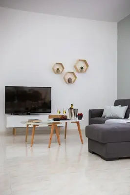 a living room with a couch and a coffee table at M & S Villa - 4 bedroom villa with heated pool in Pastida