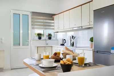 a kitchen with a table with breakfast foods and orange juice at M & S Villa - 4 bedroom villa with heated pool in Pastida