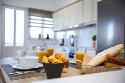 a kitchen with a table with bread and a bowl of food at M & S Villa - 4 bedroom villa with heated pool in Pastida