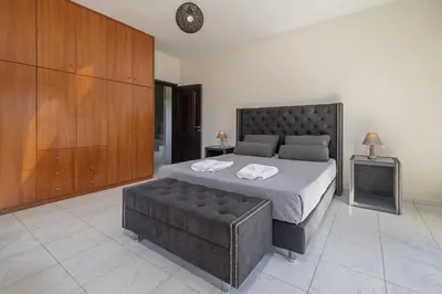 a bedroom with a large bed and a couch at Luxury Mansion Rhodes in Ialyssos