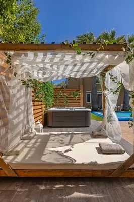 a bed under a pergola in a backyard at Luxury Mansion Rhodes in Ialyssos