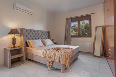 a bedroom with a large bed and a window at Luxury Mansion Rhodes in Ialyssos