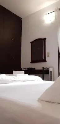 a bedroom with two beds and a flat screen tv at Gompos Apartment - Cozy Apartment next to the sea - Amazing Sea View in Symi