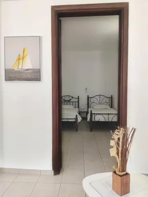 a mirror in a room with two beds at Gompos Apartment - Cozy Apartment next to the sea - Amazing Sea View in Symi