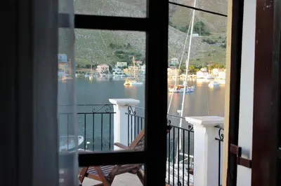 a view of a marina from a balcony at Gompos Apartment - Cozy Apartment next to the sea - Amazing Sea View in Symi