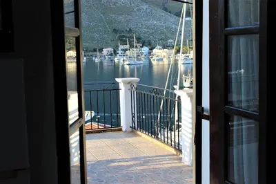a view of a marina from a house balcony at Gompos Apartment - Cozy Apartment next to the sea - Amazing Sea View in Symi