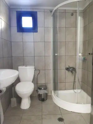 a bathroom with a toilet and a shower and a sink at Gompos Apartment - Cozy Apartment next to the sea - Amazing Sea View in Symi