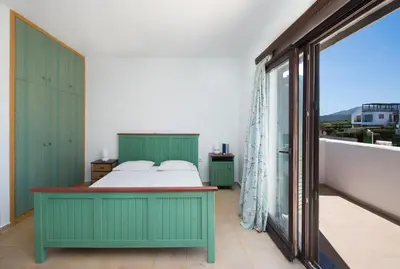 a bedroom with a bed and a large window at Cedrus and Sea, beachfront house, Gennadi, Rhodes in Gennadi