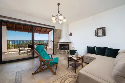a living room with a couch and a fireplace at Cedrus and Sea, beachfront house, Gennadi, Rhodes in Gennadi