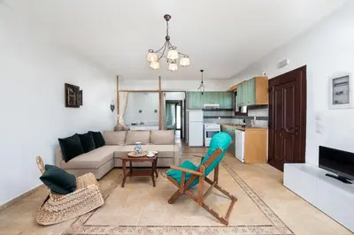 a living room with a couch and a table and chairs at Cedrus and Sea, beachfront house, Gennadi, Rhodes in Gennadi