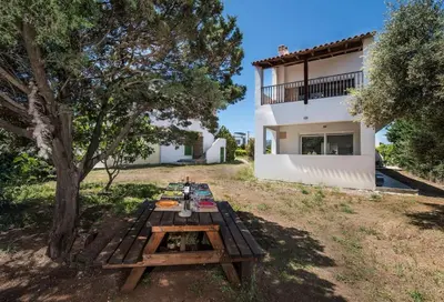 a picnic table in a yard next to a house at Cedrus and Sea, beachfront house, Gennadi, Rhodes in Gennadi