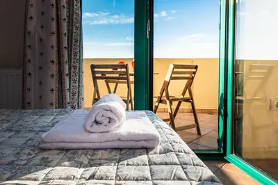 a bedroom with a bed with towels on it at Anemos Villa in Sálakos