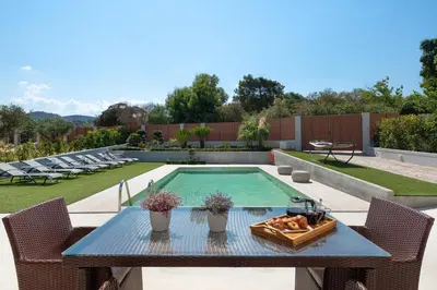 a table with a bowl of food on it next to a pool at IL PARADISO DI MICHAIL in Phanaes
