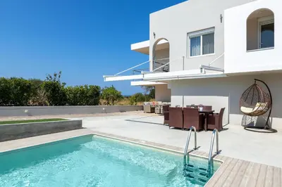 a villa with a swimming pool and a house at IL PARADISO DI MICHAIL in Phanaes