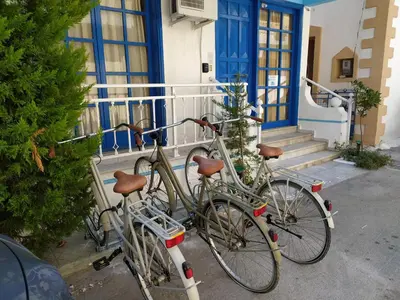 two bikes are parked outside of a building at Nitsas studio's in Kremasti