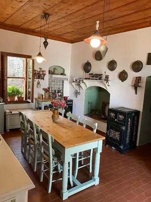 a kitchen with a wooden table with chairs and an oven at Astradeni in Symi