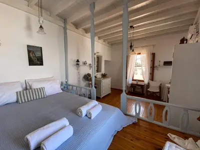 a bedroom with a bed with towels on it at Astradeni in Symi