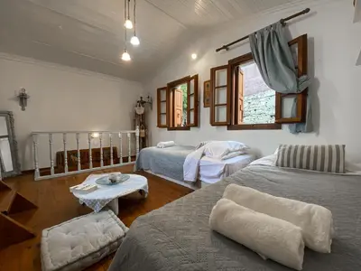 a living room with two beds and a table at Astradeni in Symi