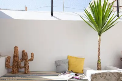 a living room with a couch and a palm tree at Avra in Symi