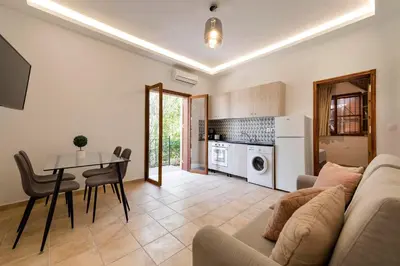 a living room with a couch and a table at Ariadni Villas Faliraki in Faliraki