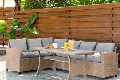 a table and chairs and a couch on a patio at Ariadni Villas Faliraki in Faliraki